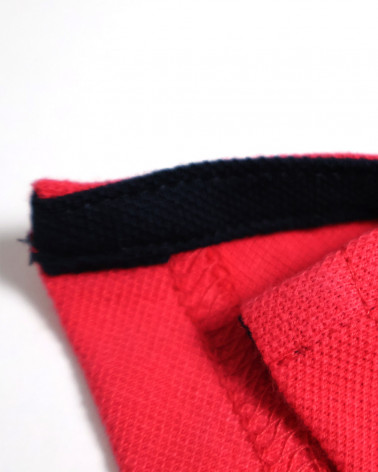 patte d'ouvertures latérales du Polo manches courtes Lorenzo Otago rugby corail pour homme