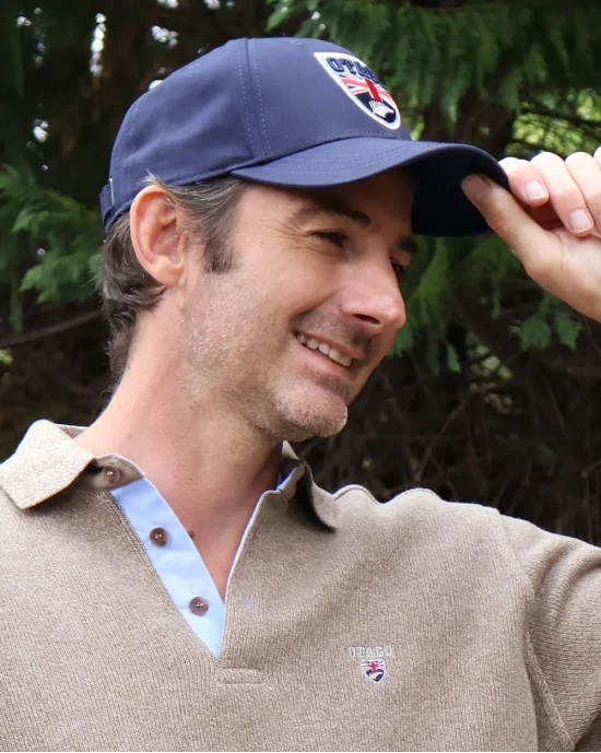 le modèle porte un Polo manches longues pour homme 25POML1 Otago rugby marron brodé côté cœur